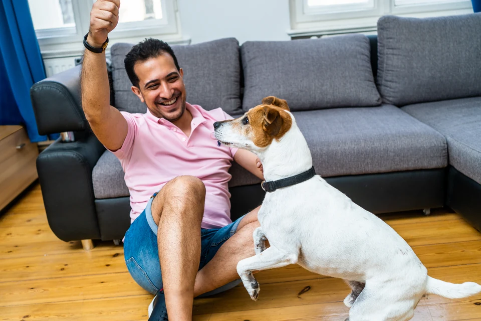 Dr. Farshad Goodarzi playing with his dog at home